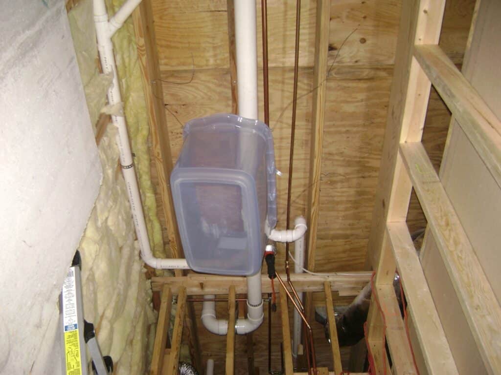 Basement Bathroom Sewer Line: Plastic Storage Bin for Catching the Debris