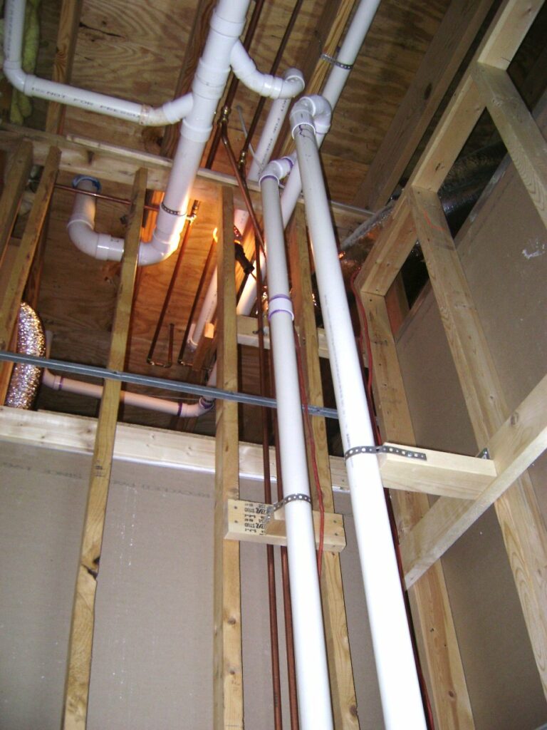 Basement Bathroom Plumbing: PVC Pipe Support Straps and Blocks