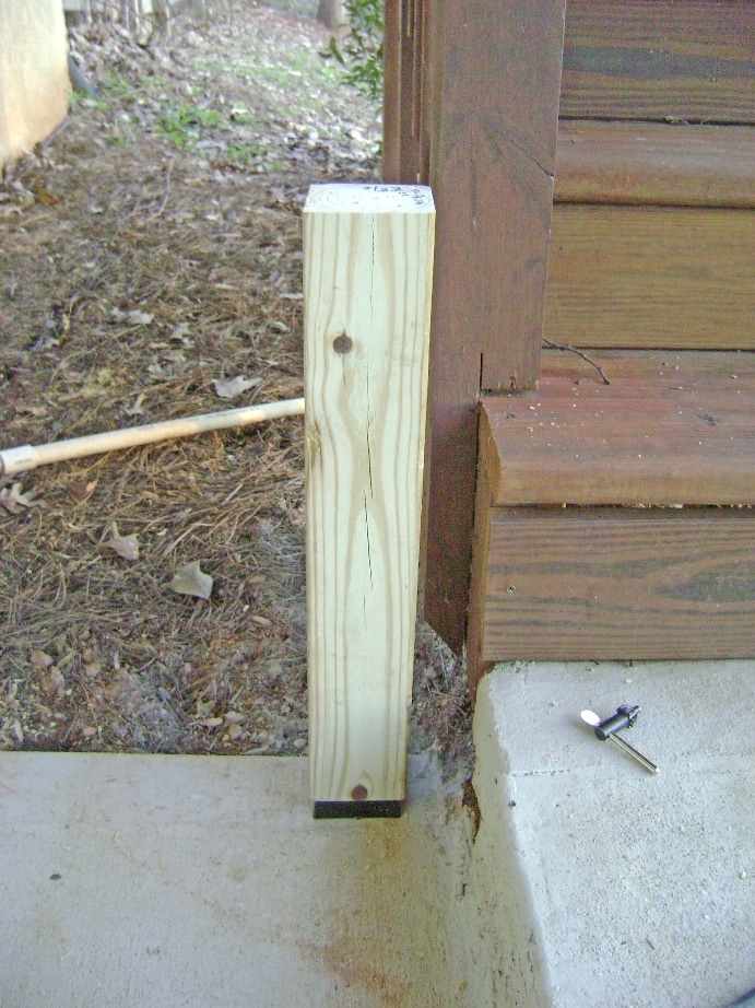 Build a Deck Rail on a Concrete Patio: Set the Post on the Anchor Pin