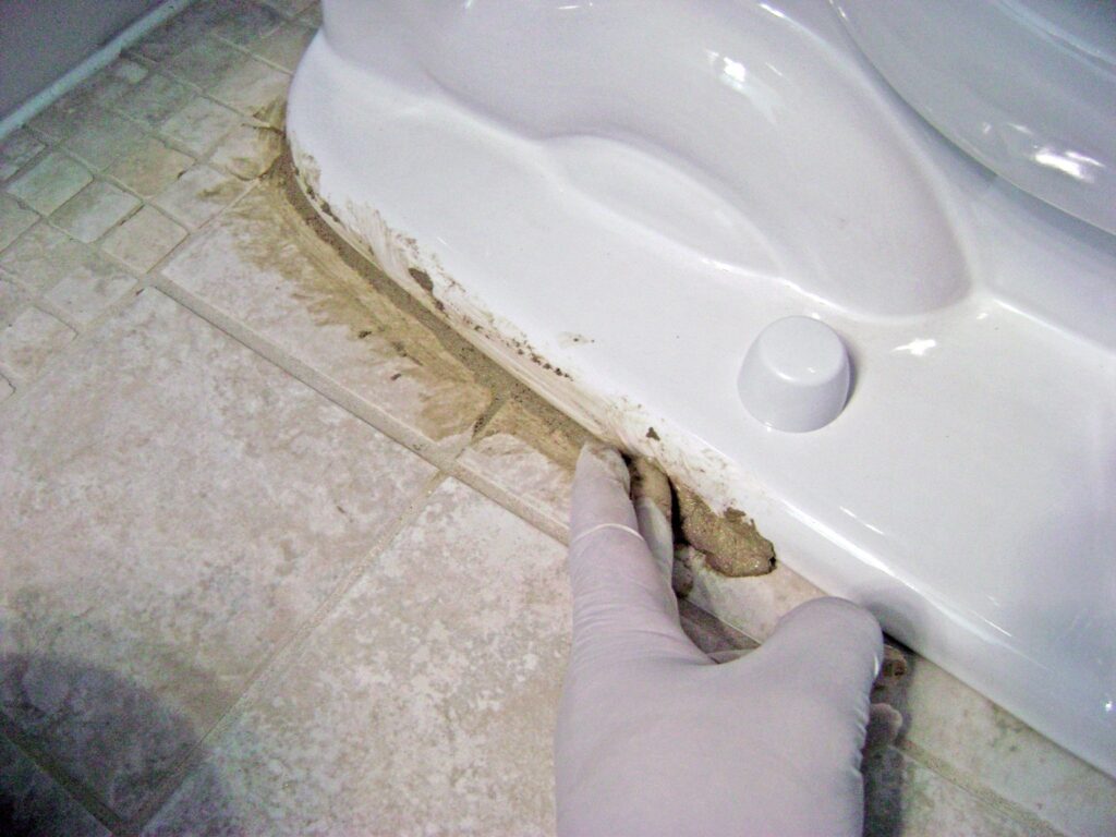 Grout the Toilet Bowl on the Tile Floor