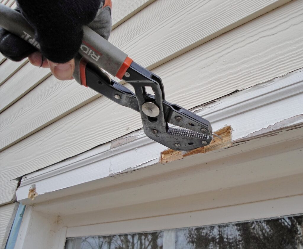 Pulling Staples from the Window Casing with Pliers