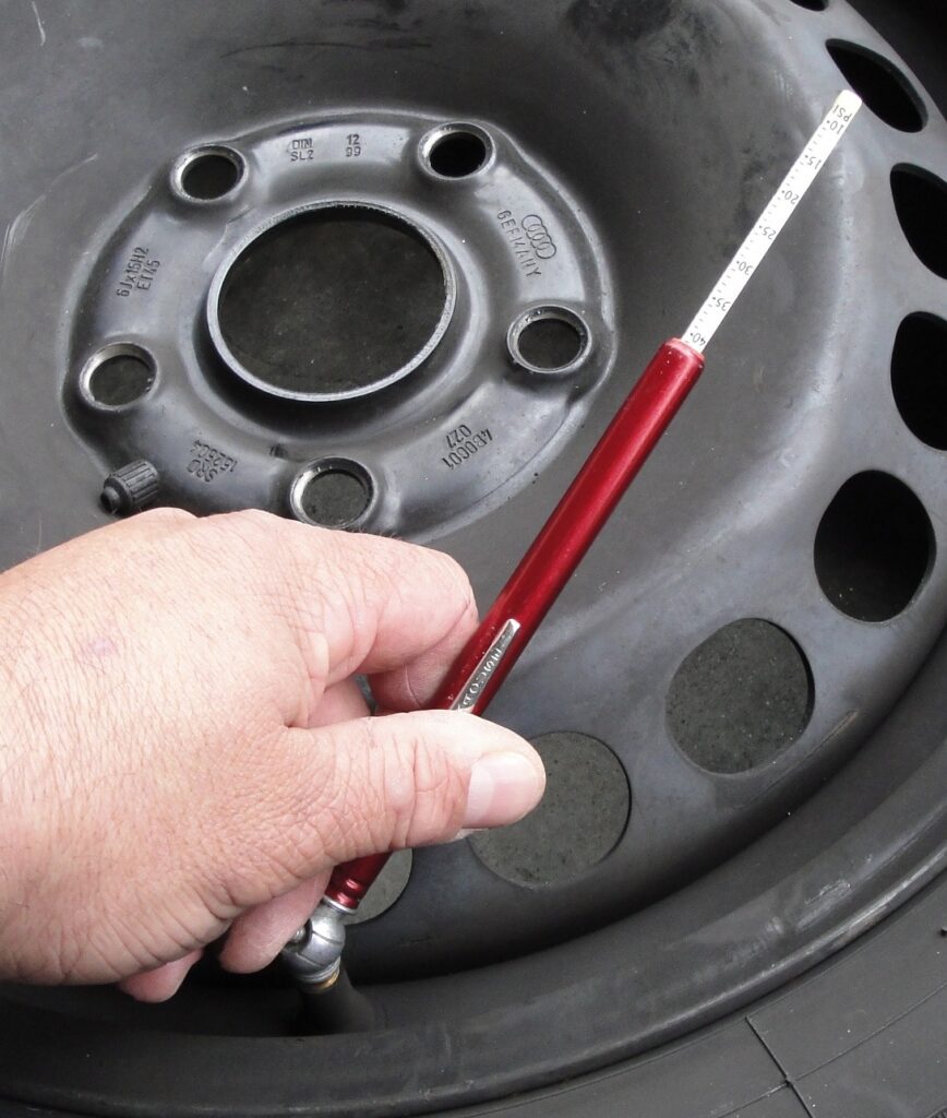 Fix a Flat Car Tire: Check the Tire Pressure with a Gauge