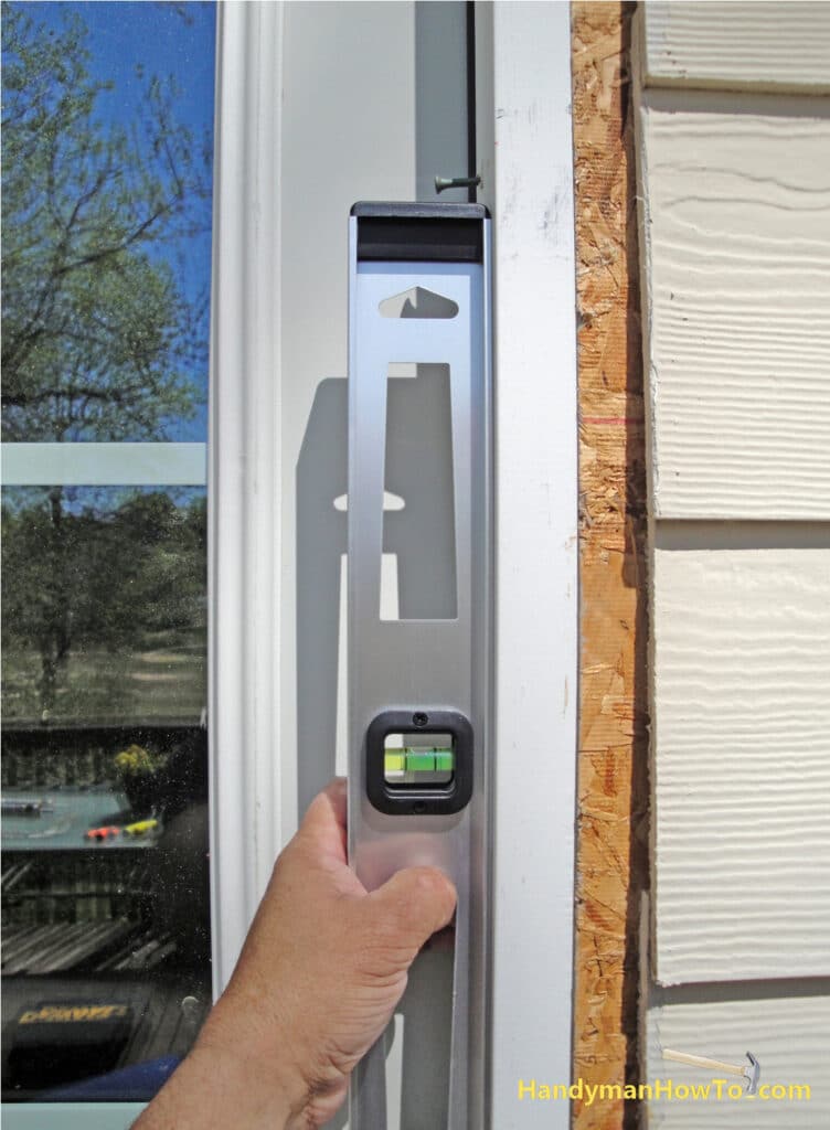 Plumb the Hinge Side of the Exterior Door Frame with a Level