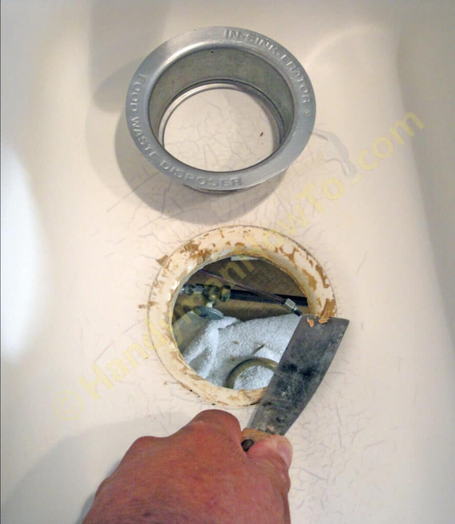 Remove the Garbage Disposal Sink Flange and Scrape off the Plumber's Putty