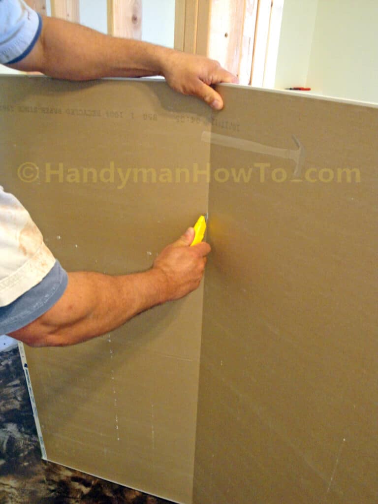 Drywall Installation: Scoring the Cut Line with a Utility Knife